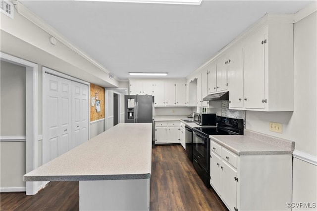 3401 Quail Hill Dr, Chesterfield, VA 23112 - kitchen with stainless steel appliances, under cabinet range hood, white cabinets, dark wood finished floors, and light countertops
