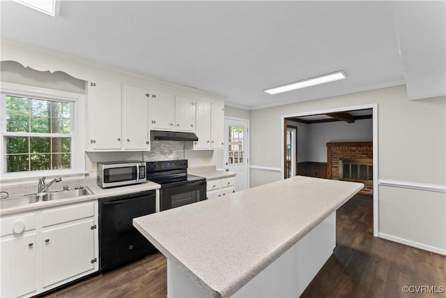 3401 Quail Hill Dr, Chesterfield, VA 23112 - kitchen featuring black appliances, under cabinet range hood, light countertops, white cabinetry, and ornamental molding