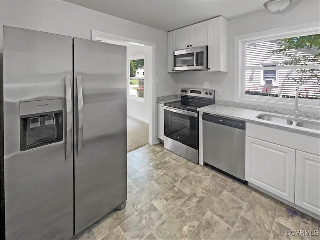 943 Barlen Dr, Richmond, VA 23225 - kitchen featuring stainless steel appliances, white cabinetry, light stone countertops, and light stone finish flooring