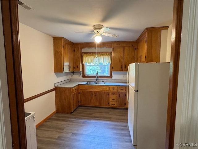 516 Kramer Dr, Highland Springs, VA 23075 - kitchen with freestanding refrigerator, brown cabinetry, ceiling fan, wood finished floors, and light countertops