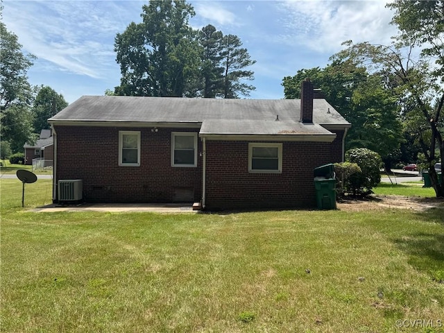 516 Kramer Dr, Highland Springs, VA 23075 - rear view of house with a yard, brick siding, and a chimney