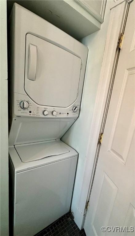 2227 Park Ave, Richmond, VA 23220 - laundry area with estacked washer and dryer and dark tile patterned flooring