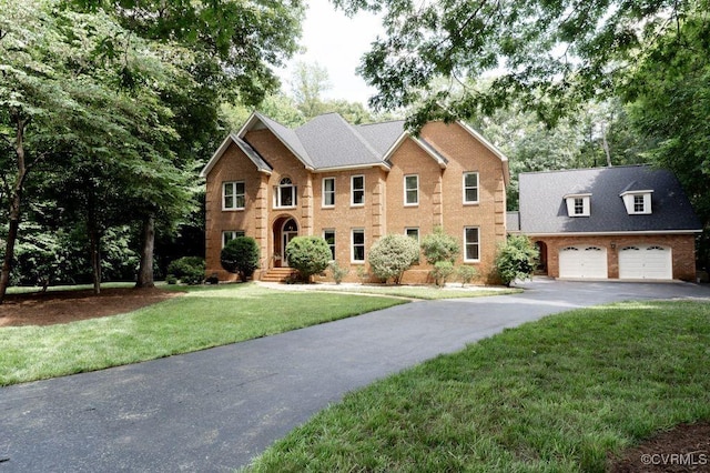 9307 Oak Trl, Ashland, VA 23005 - view of front of home featuring driveway, brick siding, and a front lawn