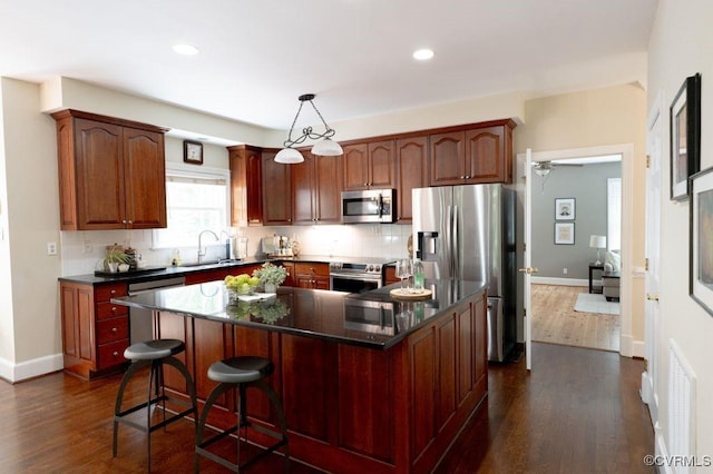 9307 Oak Trl, Ashland, VA 23005 - kitchen featuring stainless steel appliances, dark wood-style floors, dark countertops, backsplash, and recessed lighting