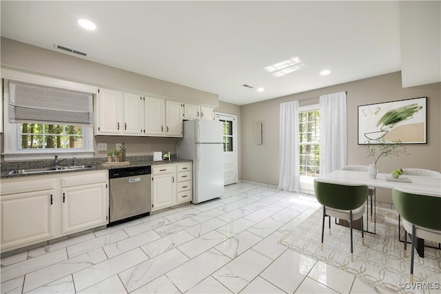 4605 Kingsrow Ct, Glen Allen, VA 23060 - kitchen with stainless steel dishwasher, freestanding refrigerator, light marble finish flooring, dark stone counters, and white cabinetry