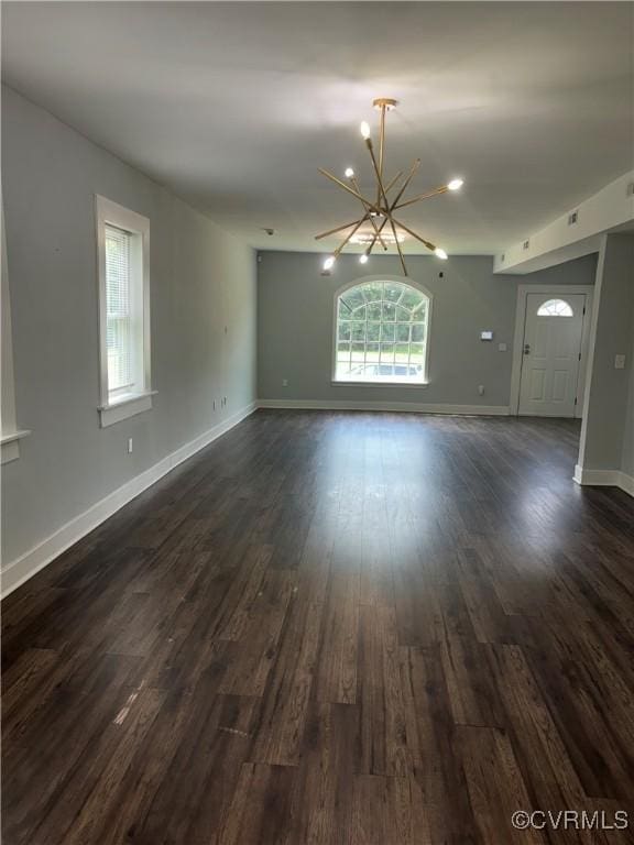 924 Lee Ave, Petersburg, VA 23803 - unfurnished living room with a chandelier and dark wood-type flooring
