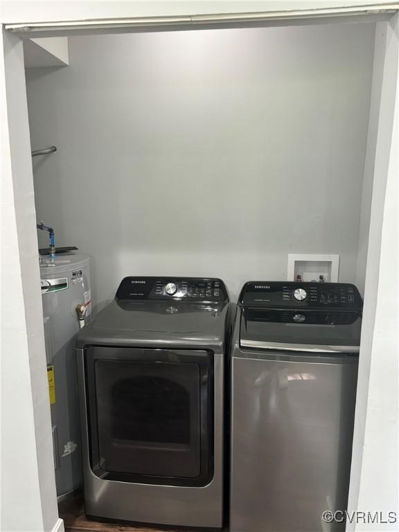924 Lee Ave, Petersburg, VA 23803 - washroom featuring water heater, washing machine and clothes dryer, and wood finished floors