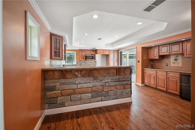 2644 Dorrell Rd, Aylett, VA 23009 - kitchen featuring a raised ceiling, decorative backsplash, recessed lighting, wood finished floors, and glass insert cabinets