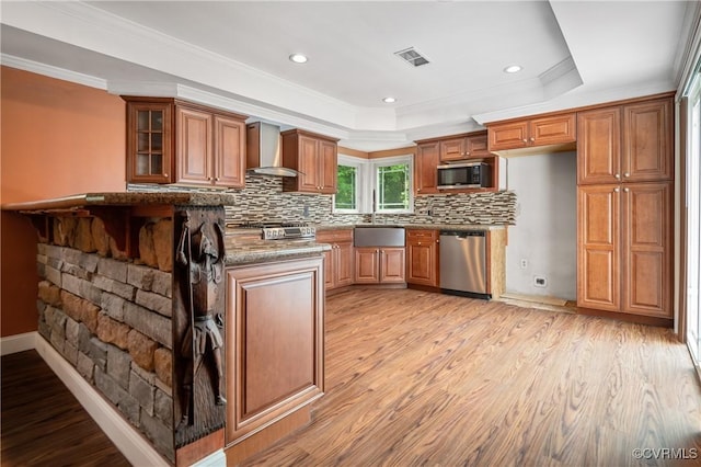 2644 Dorrell Rd, Aylett, VA 23009 - kitchen featuring stainless steel appliances, wall chimney range hood, a raised ceiling, brown cabinetry, and tasteful backsplash