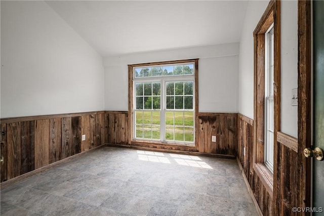 2644 Dorrell Rd, Aylett, VA 23009 - empty room with a wainscoted wall, wooden walls, lofted ceiling, and stone finish flooring