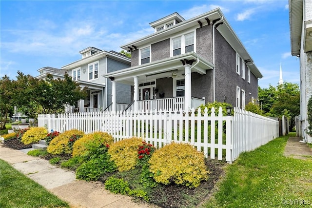 2805 Griffin Ave, Richmond, VA 23222 - american foursquare style home with a porch, a fenced front yard, and stucco siding