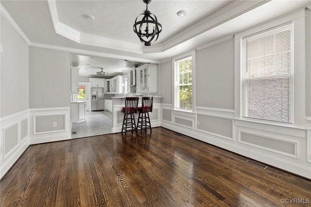 2805 Griffin Ave, Richmond, VA 23222 - living room with healthy amount of natural light, a tray ceiling, a chandelier, a decorative wall, and a wainscoted wall