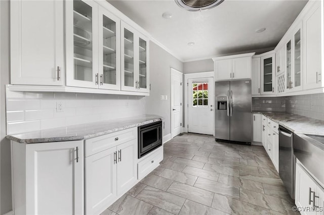 2805 Griffin Ave, Richmond, VA 23222 - kitchen featuring appliances with stainless steel finishes, light stone counters, glass insert cabinets, white cabinetry, and decorative backsplash