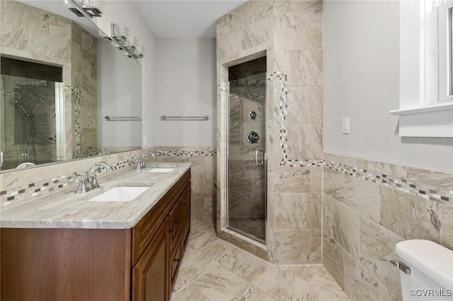 2805 Griffin Ave, Richmond, VA 23222 - bathroom with tile walls, double vanity, a shower stall, wainscoting, and marble finish flooring