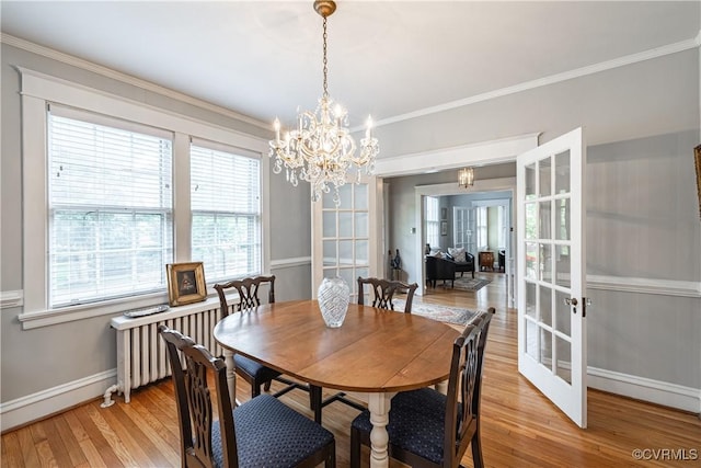 5013 Caledonia Rd, Richmond, VA 23225 - dining room with plenty of natural light, radiator heating unit, light wood finished floors, crown molding, and a chandelier