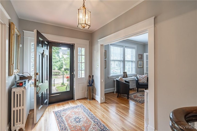5013 Caledonia Rd, Richmond, VA 23225 - entrance foyer featuring radiator heating unit, healthy amount of natural light, light wood-type flooring, ornamental molding, and a chandelier