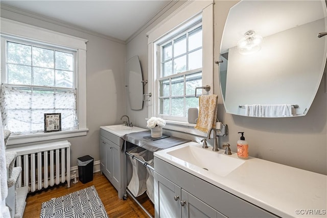 5013 Caledonia Rd, Richmond, VA 23225 - kitchen with gray cabinetry, radiator, wood finished floors, healthy amount of natural light, and crown molding