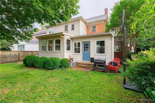 5013 Caledonia Rd, Richmond, VA 23225 - rear view of property featuring entry steps, a chimney, and brick siding