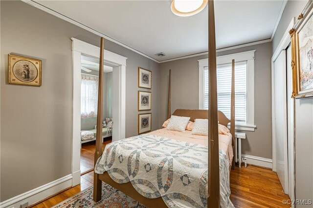 5013 Caledonia Rd, Richmond, VA 23225 - bedroom with ornamental molding, wood finished floors, and multiple windows
