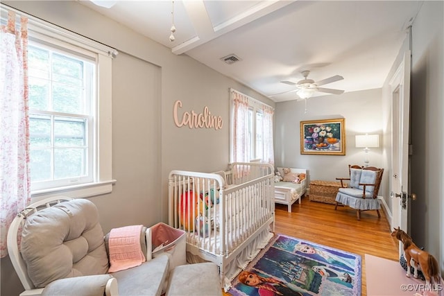5013 Caledonia Rd, Richmond, VA 23225 - bedroom featuring wood finished floors and a crib