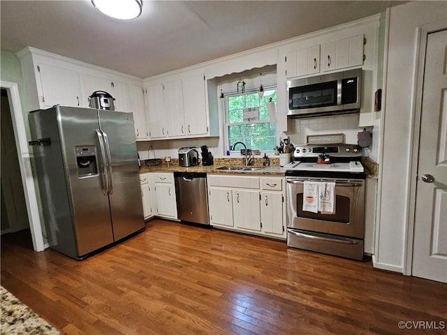 7106 Full Rack Dr, Midlothian, VA 23112 - kitchen with stainless steel appliances, dark wood-style floors, white cabinetry, and backsplash