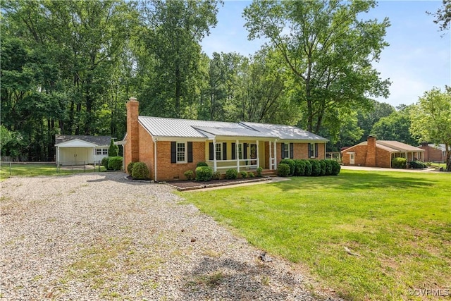 14410 Ranger Rd, Chesterfield, VA 23838 - ranch-style house featuring brick siding, gravel driveway, a chimney, a porch, and a metal roof