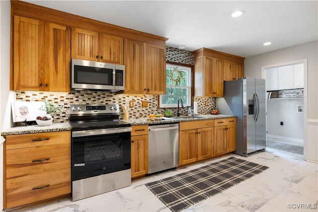 14410 Ranger Rd, Chesterfield, VA 23838 - kitchen with appliances with stainless steel finishes, light marble finish flooring, decorative backsplash, light stone countertops, and brown cabinetry