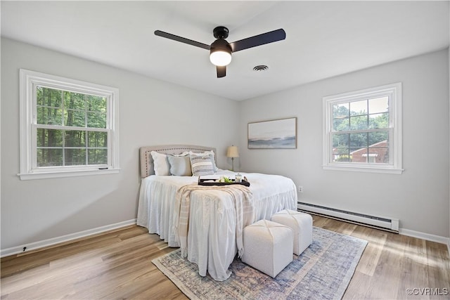 14410 Ranger Rd, Chesterfield, VA 23838 - bedroom with a baseboard heating unit, light wood-style flooring, and a ceiling fan