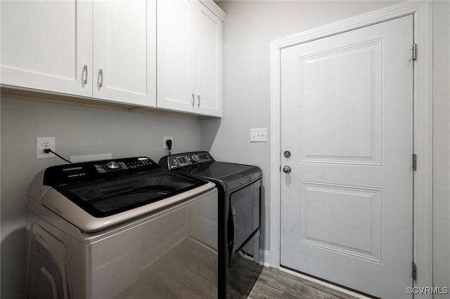 100 Heron Run Dr, Colonial Heights, VA 23834 - laundry area featuring washing machine and dryer, cabinet space, and wood finished floors