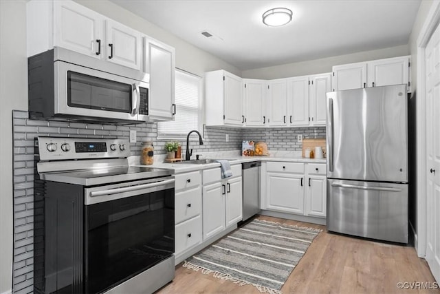 5908 Meadwood Cir, Chesterfield, VA 23234 - kitchen featuring appliances with stainless steel finishes, light countertops, white cabinets, and backsplash