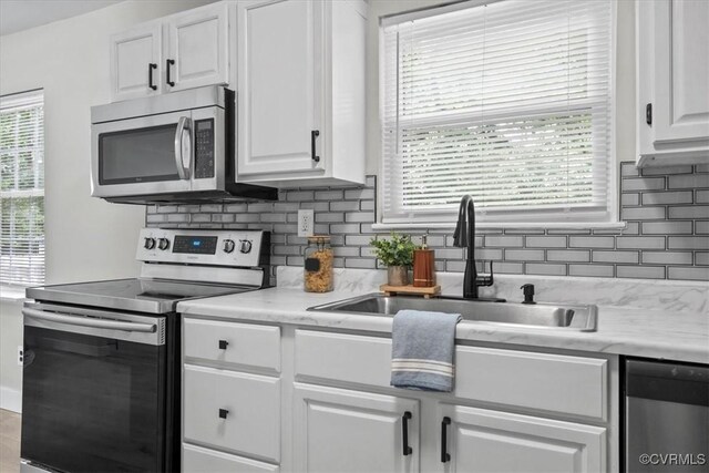 5908 Meadwood Cir, Chesterfield, VA 23234 - kitchen featuring appliances with stainless steel finishes, white cabinets, tasteful backsplash, and light countertops