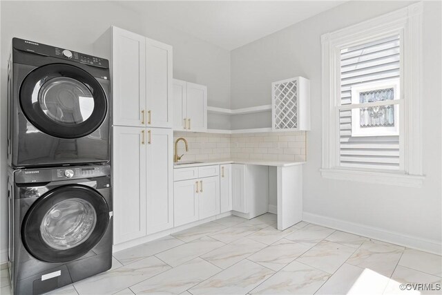 2013 N Ave, Richmond, VA 23222 - washroom featuring estacked washer and dryer, cabinet space, and light marble finish flooring