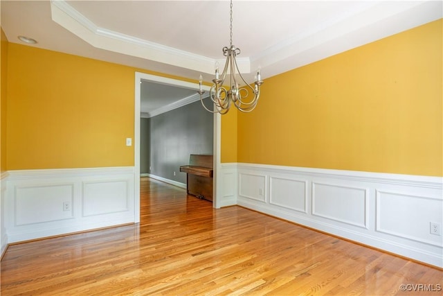 706 Colony Oak Ln, Midlothian, VA 23114 - unfurnished room featuring a chandelier, ornamental molding, wainscoting, light wood-type flooring, and a tray ceiling