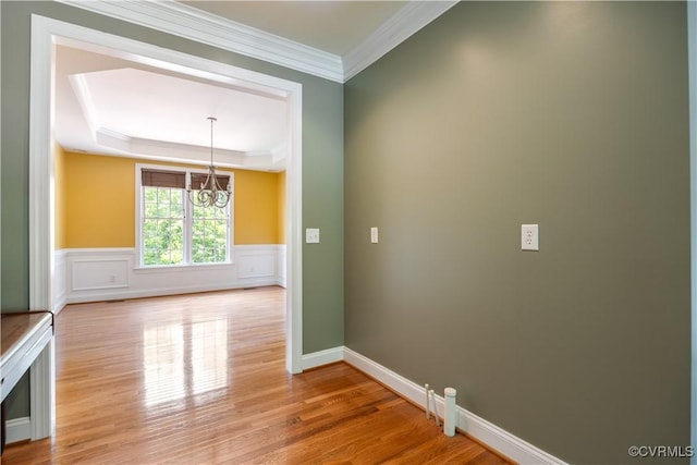 706 Colony Oak Ln, Midlothian, VA 23114 - unfurnished room featuring a chandelier, light wood finished floors, a tray ceiling, ornamental molding, and a wainscoted wall