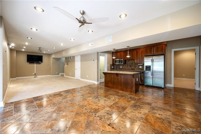 706 Colony Oak Ln, Midlothian, VA 23114 - kitchen with stainless steel appliances, a kitchen island, a breakfast bar area, a ceiling fan, and stone finish flooring
