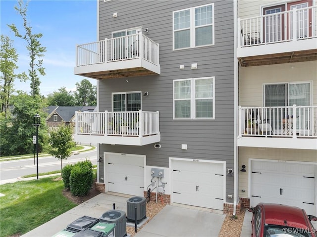 8034 Wistar Glen Dr Unit A, Henrico, VA 23228 - rear view of property featuring a balcony, a garage, and concrete driveway