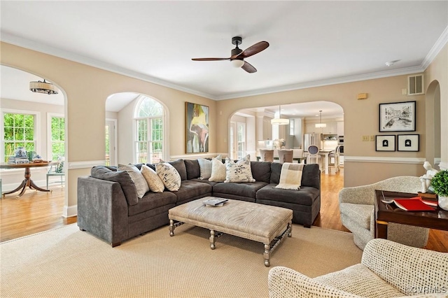 9408 Arrowdel Rd, Henrico, VA 23229 - living area featuring arched walkways, ceiling fan, ornamental molding, and light wood-style flooring