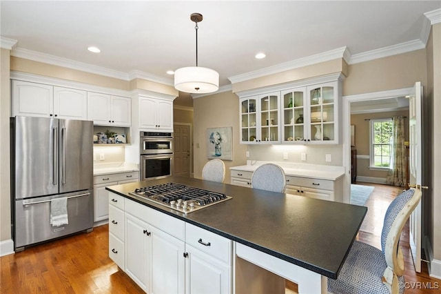 9408 Arrowdel Rd, Henrico, VA 23229 - kitchen featuring appliances with stainless steel finishes, glass insert cabinets, white cabinetry, dark wood-type flooring, and crown molding