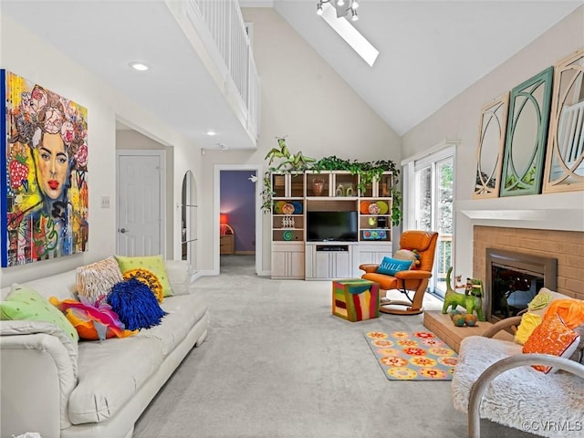 1203 Wesanne Ln, Chesterfield, VA 23114 - living room featuring high vaulted ceiling, a skylight, carpet, and a fireplace