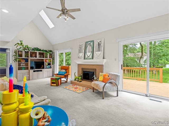 1203 Wesanne Ln, Chesterfield, VA 23114 - carpeted living room with high vaulted ceiling, ceiling fan, a skylight, and a fireplace