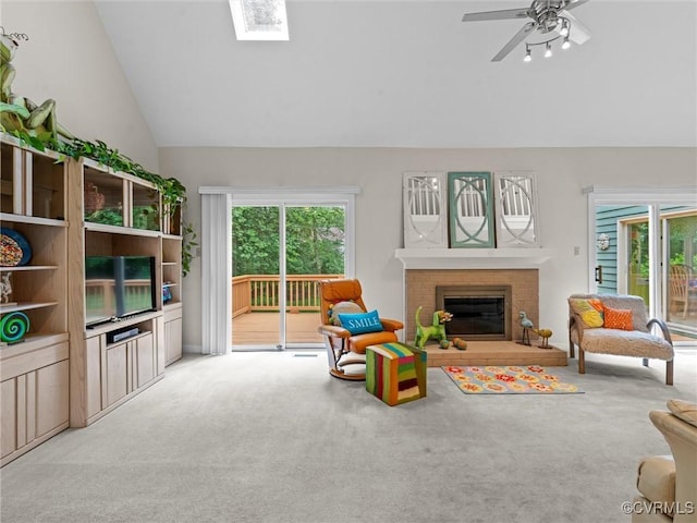 1203 Wesanne Ln, Chesterfield, VA 23114 - carpeted living area featuring plenty of natural light, a brick fireplace, ceiling fan, a skylight, and high vaulted ceiling