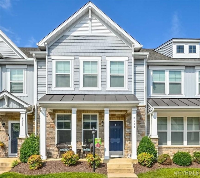 8013 Rutland Village Dr, Mechanicsville, VA 23116 - view of property featuring a standing seam roof, stone siding, a porch, and a metal roof