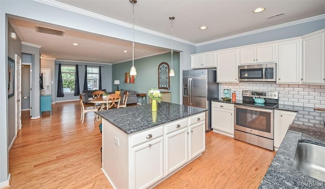8013 Rutland Village Dr, Mechanicsville, VA 23116 - kitchen featuring stainless steel appliances, ornamental molding, light wood-type flooring, white cabinets, and tasteful backsplash