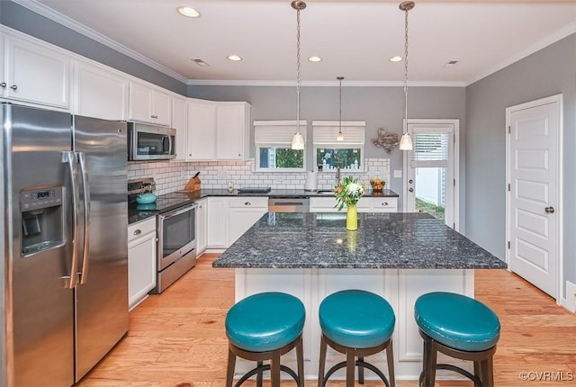 8013 Rutland Village Dr, Mechanicsville, VA 23116 - kitchen with appliances with stainless steel finishes, light wood finished floors, white cabinetry, backsplash, and ornamental molding
