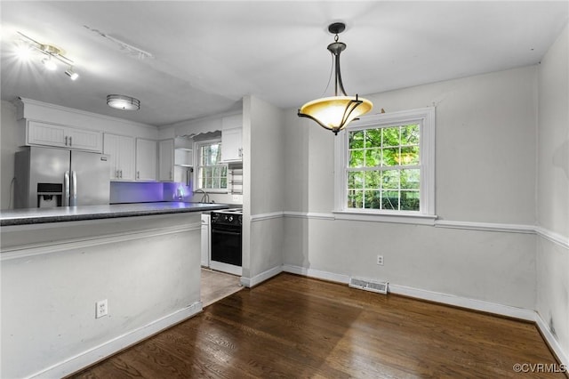 6808 Montauk Dr, Richmond, VA 23225 - kitchen with stainless steel fridge, white cabinetry, dark wood-style flooring, wall oven, and pendant lighting