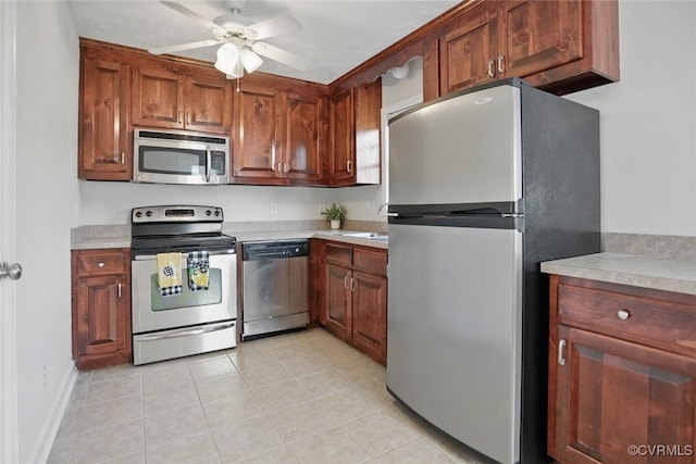 108 N Cedar Ave, Highland Springs, VA 23075 - kitchen with appliances with stainless steel finishes, light countertops, ceiling fan, light tile patterned flooring, and brown cabinets
