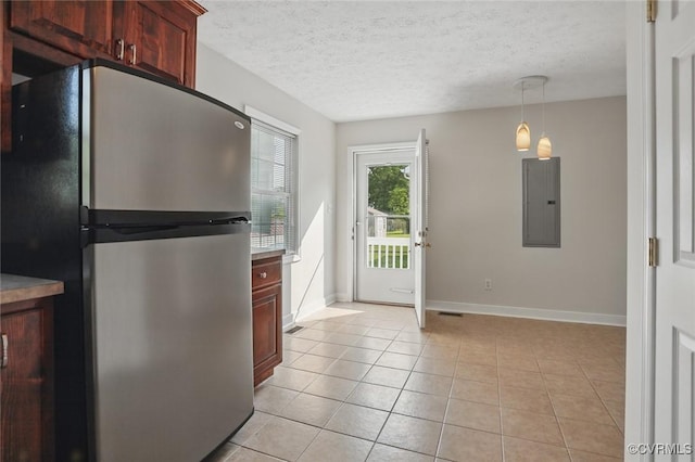 108 N Cedar Ave, Highland Springs, VA 23075 - kitchen with freestanding refrigerator, electric panel, light tile patterned floors, a textured ceiling, and decorative light fixtures