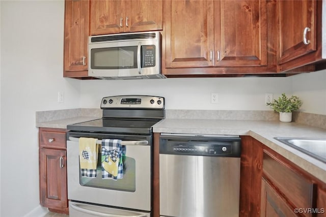 108 N Cedar Ave, Highland Springs, VA 23075 - kitchen featuring stainless steel appliances, light countertops, and brown cabinetry