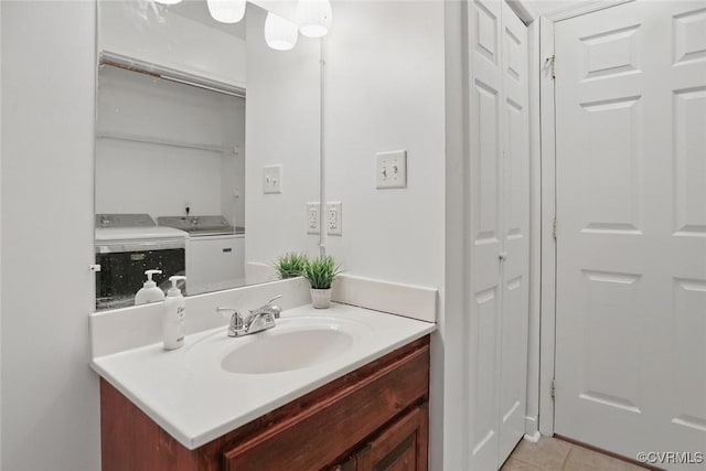 108 N Cedar Ave, Highland Springs, VA 23075 - bathroom featuring a closet, washer and clothes dryer, vanity, and tile patterned floors