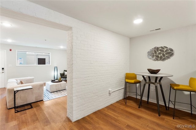 1716 Summit Ave Unit 18, Richmond, VA 23230 - hall featuring brick wall, wood finished floors, and recessed lighting